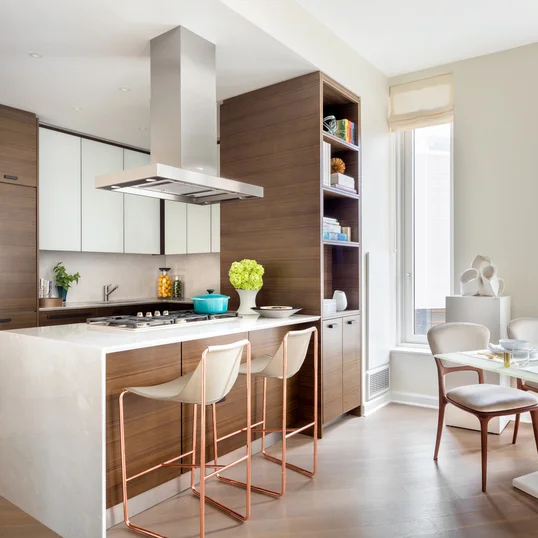 Custom kitchen cabinetry with matte black hardware, Turkish marble countertop and backsplash designed by Andre Kikoski Architect.