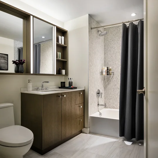 Custom bathrooms include imported Bianco Dolomite polished marble with marble mosaic feature walls