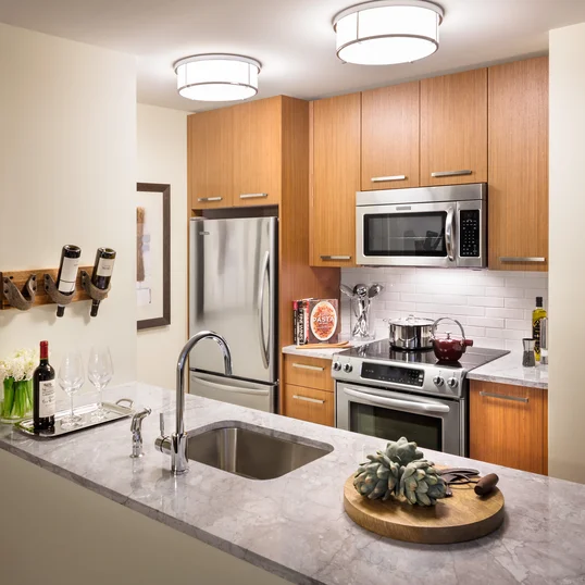 Walnut cabinetry, Italian marble countertops, and stainless steel appliances are just a few of the many ingredients that make these kitchens any chef's dream-come-true.