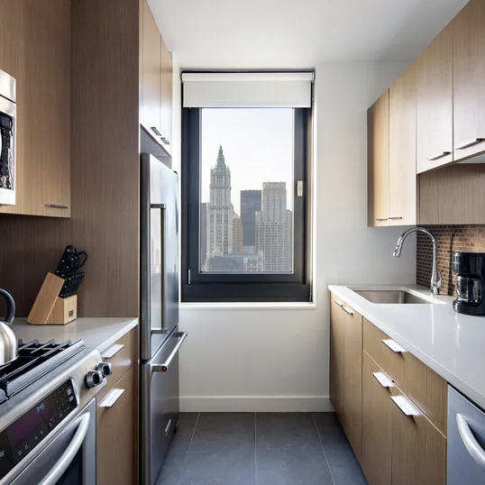 Tribeca Tower features gourmet kitchens with full-sized stainless steel appliances, custom wood cabinetry and white stone countertops. 