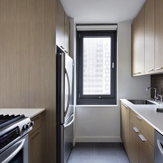 Tribeca Tower features gourmet kitchens with full-sized stainless steel appliances, custom wood cabinetry and white stone countertops. 