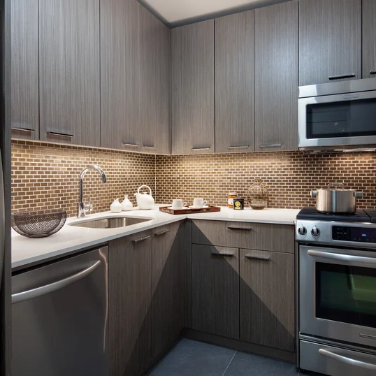 Tribeca Tower features gourmet kitchens with full-sized stainless steel appliances, custom wood cabinetry and white stone countertops. 
