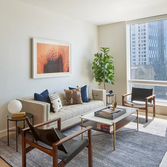 Floor-to-ceiling windows provide maximum natural light and showcase sweeping water and city views