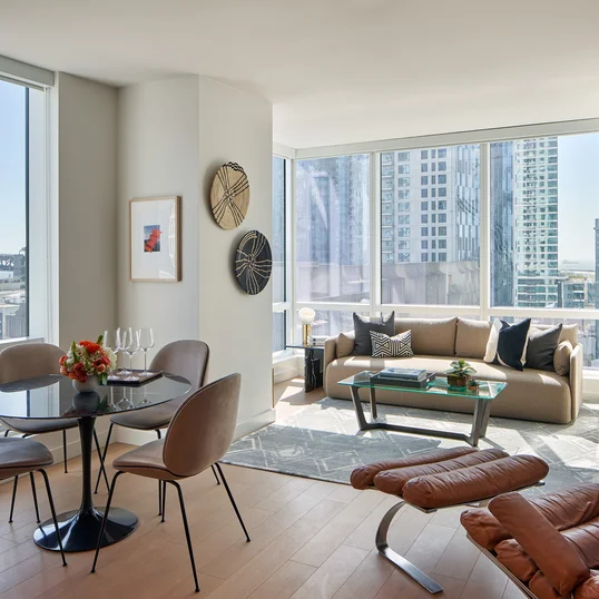 Floor-to-ceiling windows provide maximum natural light and showcase sweeping water and city views