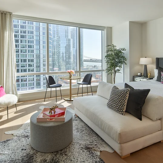 Floor-to-ceiling windows provide maximum natural light and showcase sweeping water and city views
