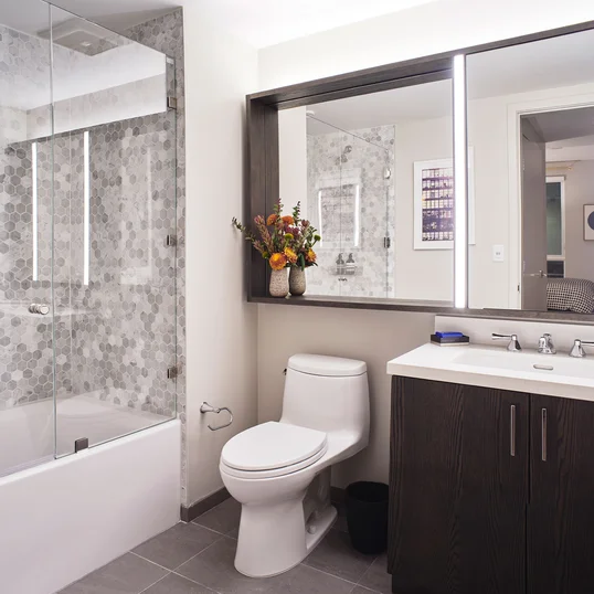 Inspired baths include a marble tub surround and glass enclosed shower, custom vanity and medicine cabinet.