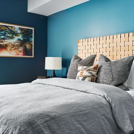 Bedrooms feature wide-plank flooring throughout and spacious closets with Elfa shelving systems.