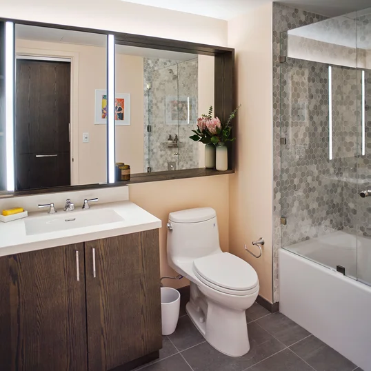 Inspired baths include a marble tub surround and glass enclosed shower, custom vanity and medicine cabinet.