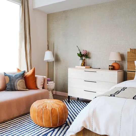 Bedrooms feature wide-plank flooring throughout and spacious closets with Elfa shelving systems.