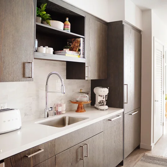 Gourmet kitchens feature gas cooktops and Bosch appliances with quartz counters and a marble backsplash.