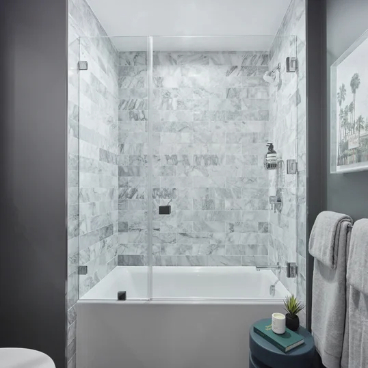Luxe bathrooms include marble tub surround.