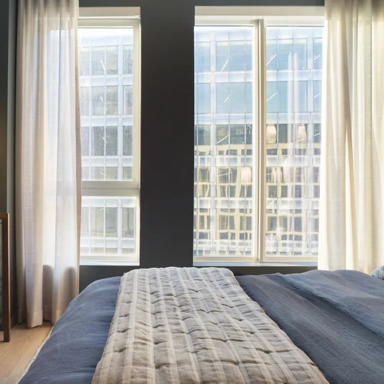 Spacious bedrooms feature blackout shades and a customizable Elfa closet-shelving system.