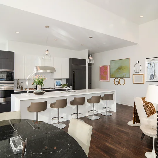 Custom-designed wide-plank wood flooring throughout residences