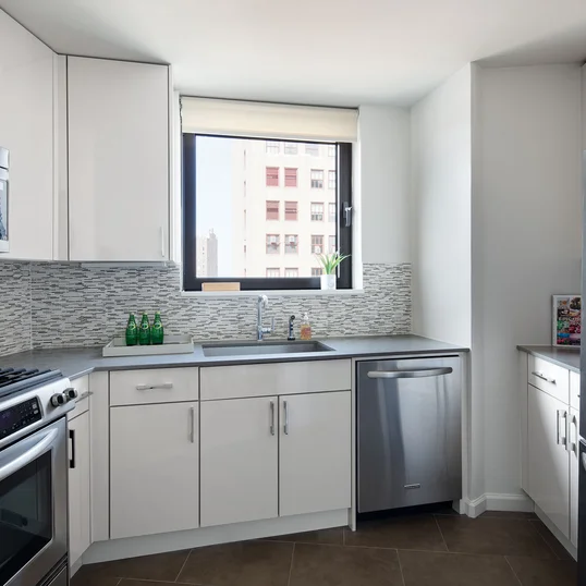 The gourmet kitchen at One Union Square South features Euro-style cabinetry and granite countertops.