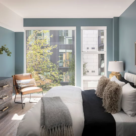 Bedrooms feature wide-plank flooring throughout and spacious closets with Elfa shelving systems.