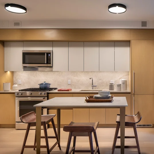 Italian designed and manufactured kitchens with custom oak cabinetry, natural Brazilian quartzite countertops and backsplash.