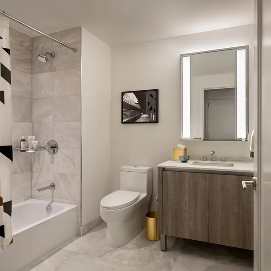 Well-appointed master bathrooms feature vanities with Italian white marble, grey marble walls, and medicine cabinets with integrated lighting and pulls.