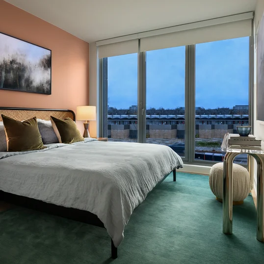 Expansive double-paned windows for maximum light, views, sound attenuation and energy efficiency with rollup solar shades for privacy and sun shading.