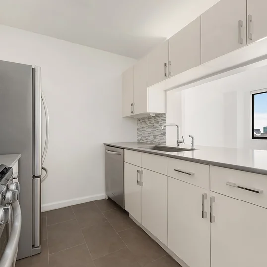 The gourmet kitchen at One Union Square South features Euro-style cabinetry and granite countertops.