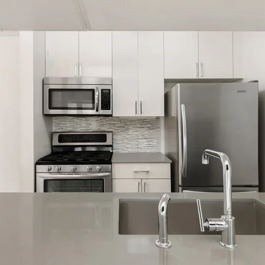 The gourmet kitchen at One Union Square South features Euro-style cabinetry and granite countertops.