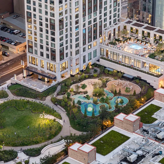 Terrace pool with lounge areas, reservable outdoor kitchens and cabanas, and fire pits.