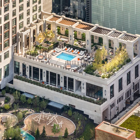 Terrace pool with lounge areas, reservable outdoor kitchens and cabanas, and fire pits.