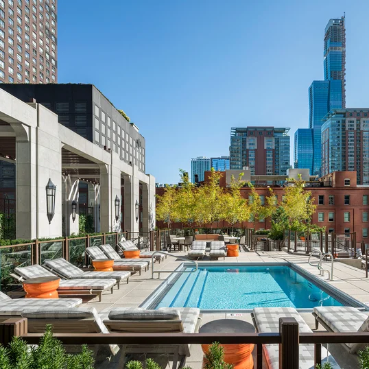 Terrace pool with lounge areas, reservable outdoor kitchens and cabanas, and fire pits.