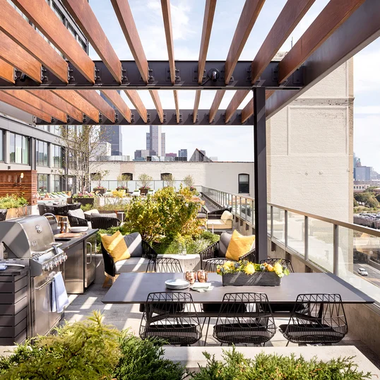 Expansive, lushly landscaped sundeck and lounge area with pool, hot tub and outdoor kitchens.