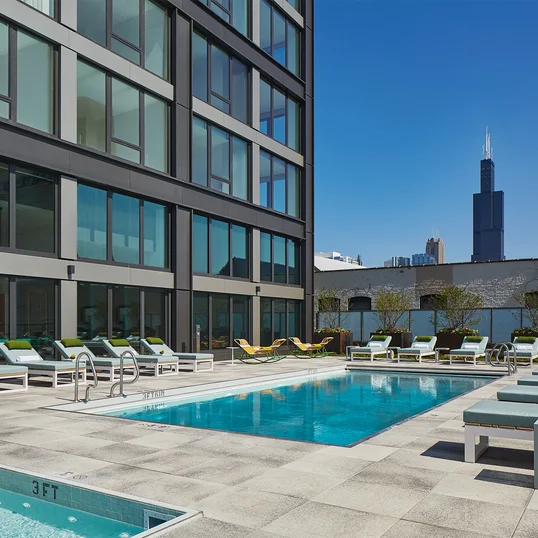 Expansive, lushly landscaped sundeck and lounge area with pool, hot tub and outdoor kitchens.