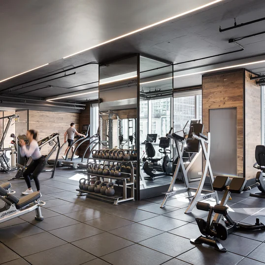 Equinox®-curated fitness center with yoga room, locker rooms and steam shower