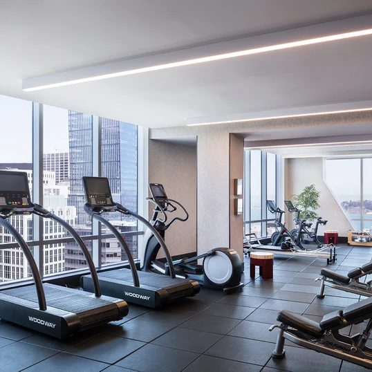 Equinox®-curated fitness center with yoga room, locker rooms and steam shower