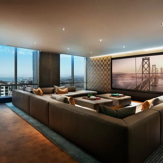 Media and game room with custom billiards table, TV, and bar