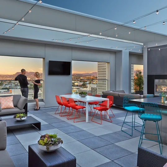 Rooftop terrace with dining tables and BBQ grills.