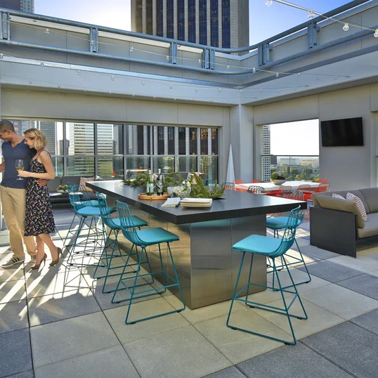 Rooftop terrace with dining tables and BBQ grills.