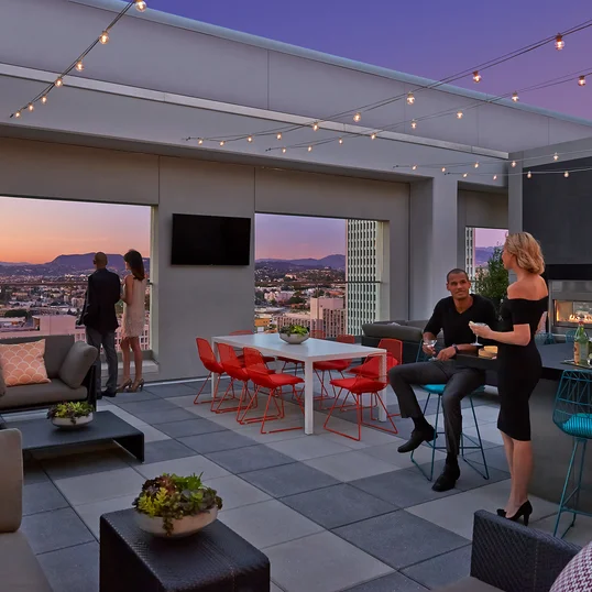 Rooftop terrace with dining tables and BBQ grills.