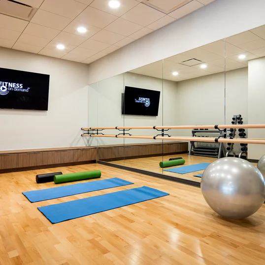 On-site yoga studio space is adjacent to the fitness center.