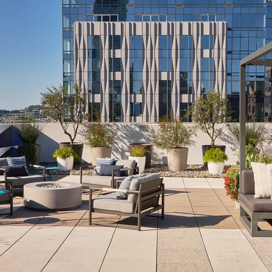 The lushly landscaped sun terrace is furnished with lounge chairs and shaded cabanas.