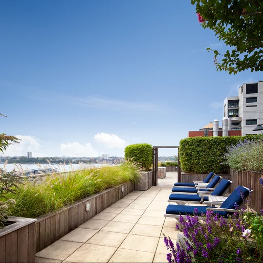 Perfectly planned landscaping on the rooftop terrace offers the ideal location to take in sweeping views of the Hudson River.