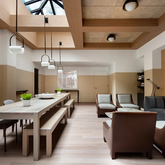 Reservable party room with large screen TV, open kitchen, and comfortable seating. 