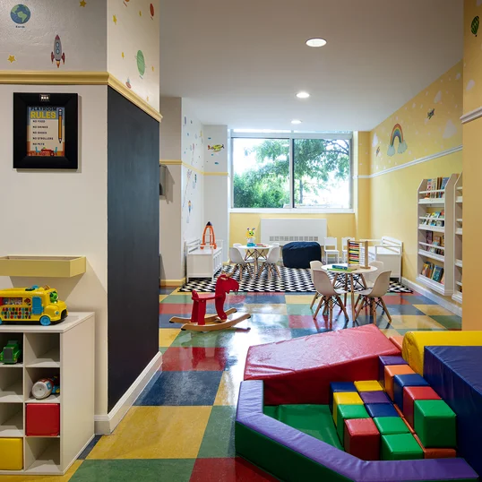 Children's playroom stocked with toys, books, and games.