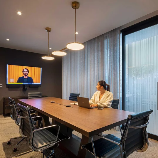 The resident-only co-working lounge includes individual workstations, private offices, and conferencing spaces.