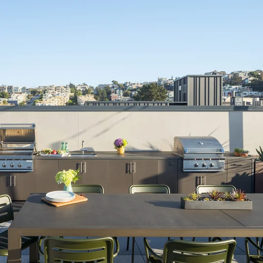 Rooftop Terrace with barbecue grills, fire pits and outdoor TVs set against views of the city skyline