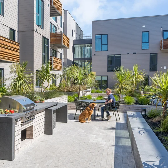 Landscaped courtyards with outdoor grills and dining