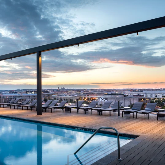 Landscaped rooftop with gunite swimming pool, two hot tubs, and resort-style sun terrace.