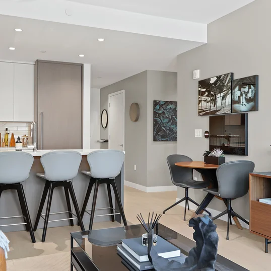 Open kitchen with custom cabinetry, premium stainless steel, gas appliances and flexible dining space