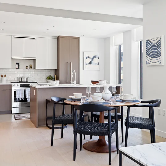 Open kitchen with custom cabinetry, premium stainless steel, gas appliances and flexible dining space