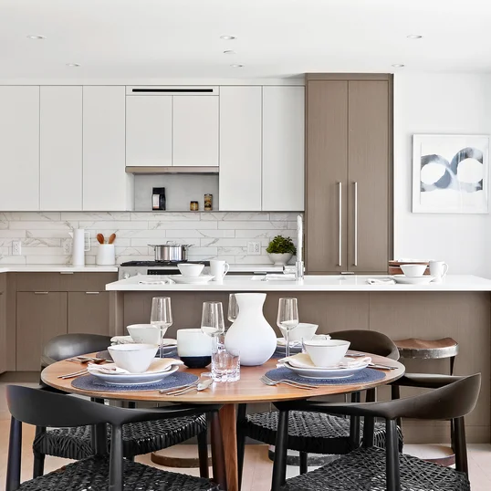 Open kitchen with custom cabinetry, premium stainless steel, gas appliances and flexible dining space