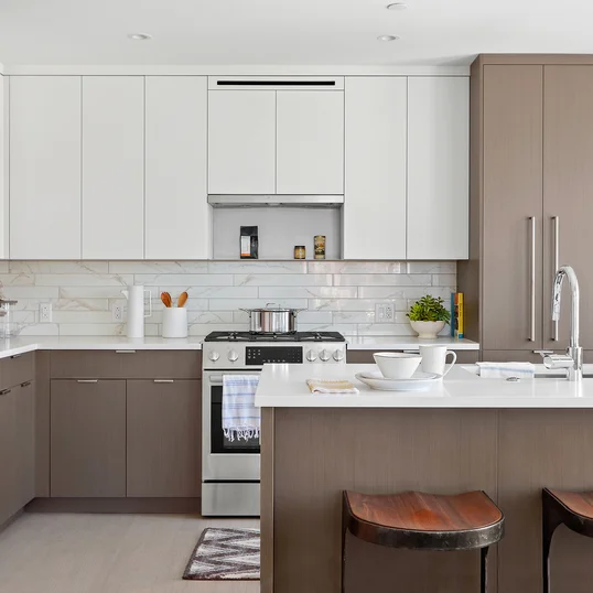 Open kitchen with custom cabinetry, premium stainless steel, gas appliances and flexible dining space