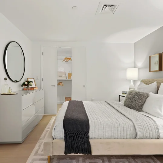 Spacious and comfortable primary bedroom with large closet space