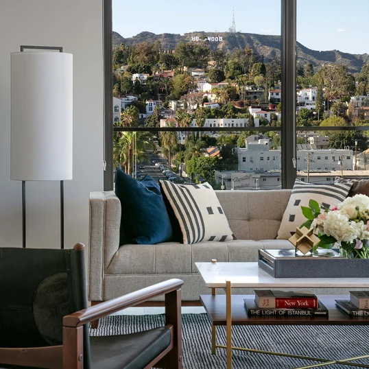 Luxe baths include a custom grey oak bathroom vanity with marble counters, frameless glass-enclosed showers with marble tile wet walls and oversized porcelain tile flooring.